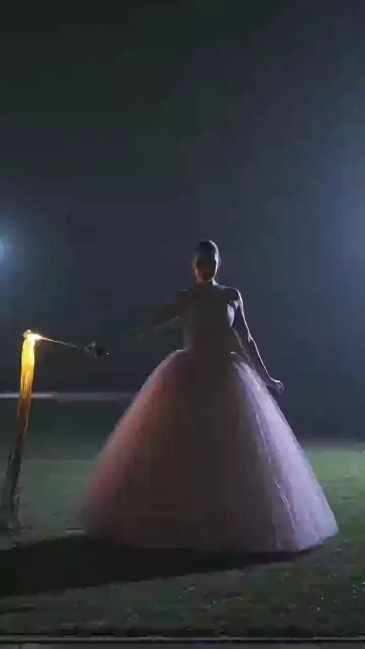 Spinning Pink Gown: Glowing Trails in the Night